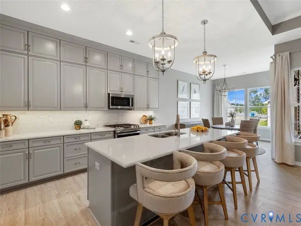 a large kitchen with a table and chairs