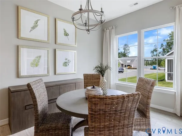 a dining room with furniture a window and a chandelier