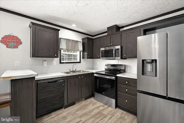 a kitchen with a sink stove and refrigerator