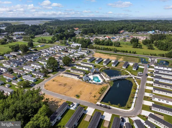 an aerial view of a pool yard and lake view in back