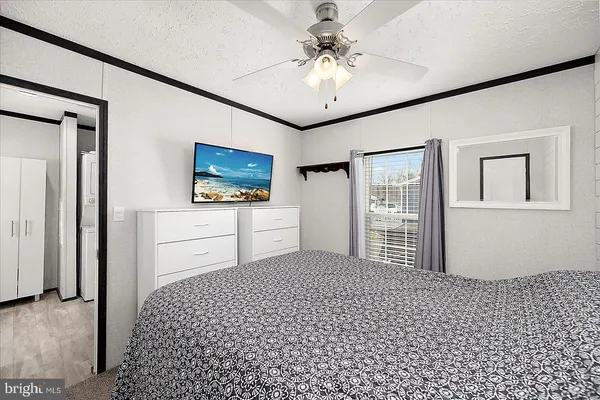 a living room with a couch dresser and a flat screen tv