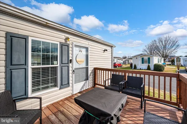 a view of a deck with a table and chairs