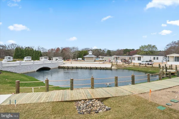 a view of swimming pool with outdoor seating and lake view