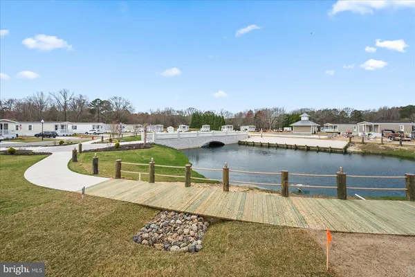 a view of a lake with a yard and mountain view