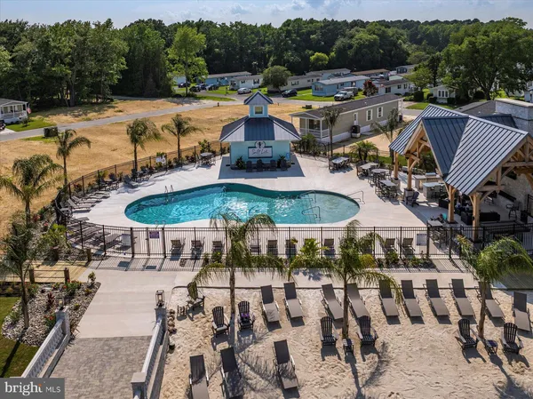 a view of a patio with swimming pool and outdoor seating