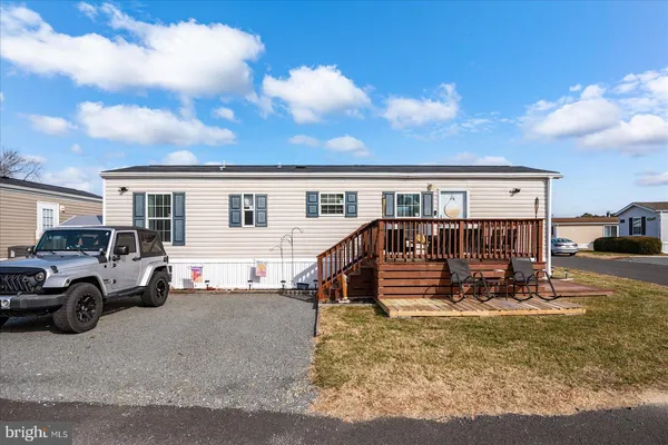 a view of a house with truck parked in front of house