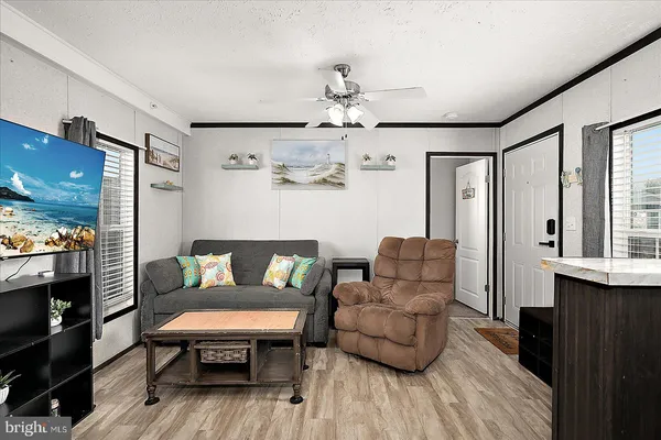 a living room with furniture and a wooden floor