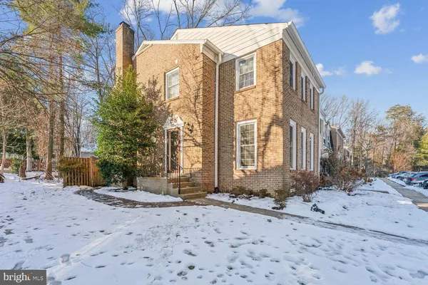 a view of a building with snow on the road