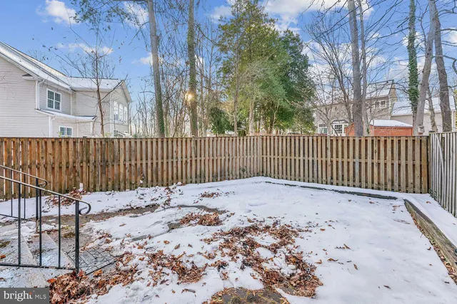 a view of a backyard with a fence