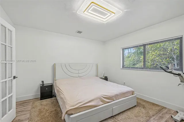 a bedroom with a bed and a window