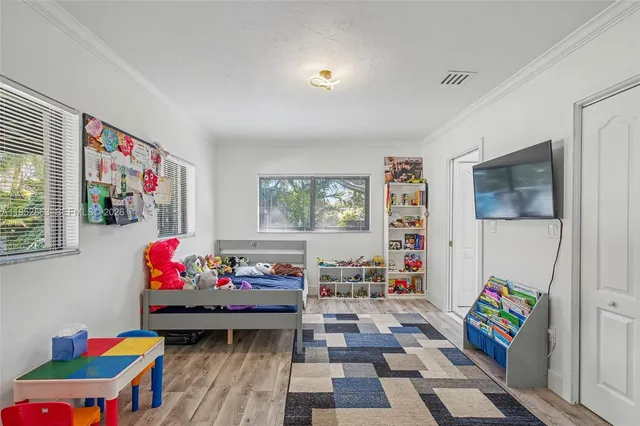 a bedroom with baby toys and wooden floor