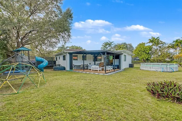 a swimming pool with plants and trees in the background
