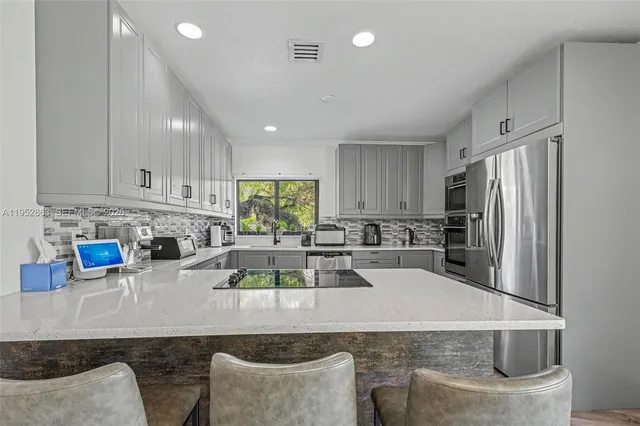 a view of a dining room with furniture wooden floor and a chandelier