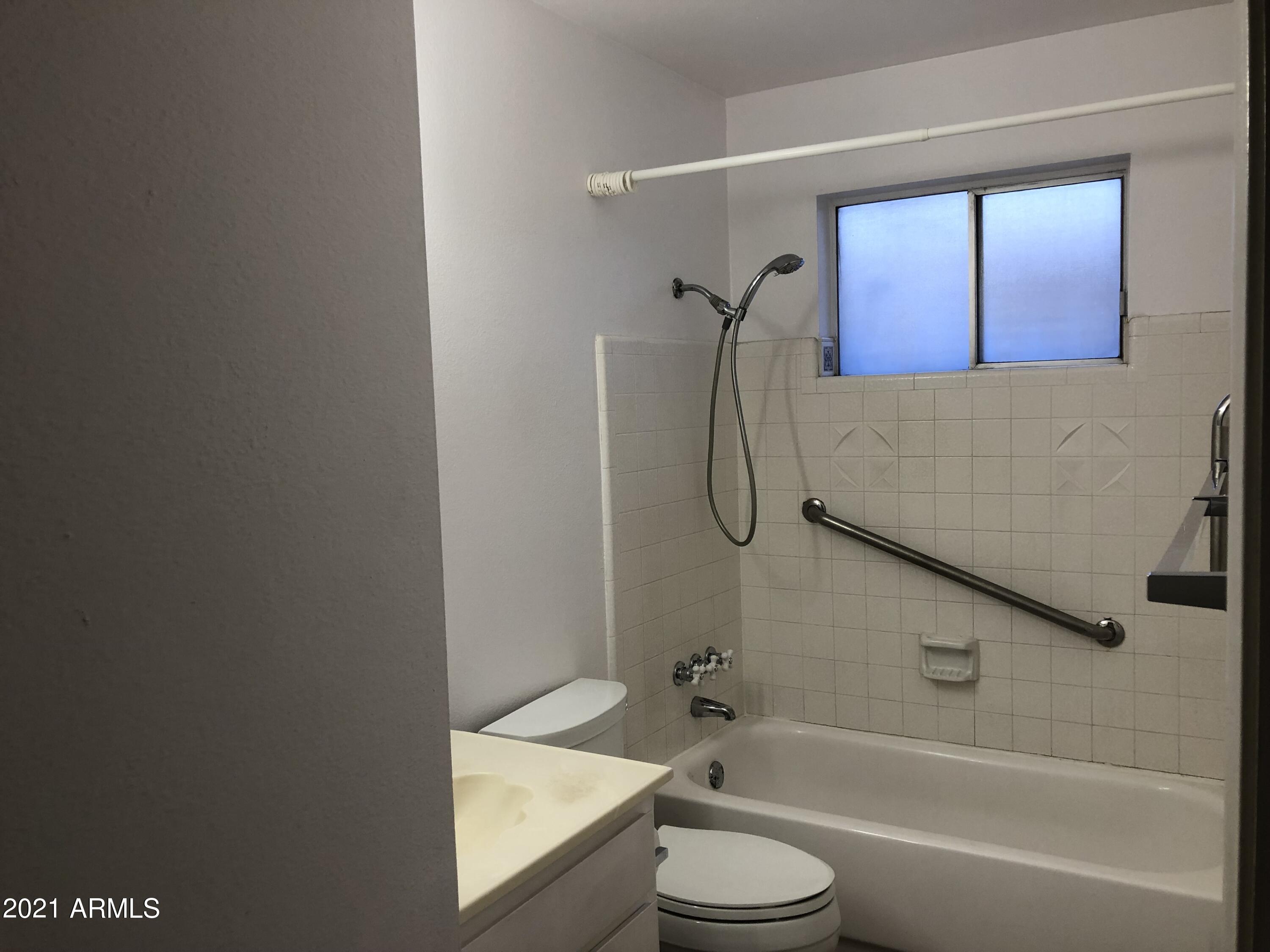 3031 South Rural Road, Unit 41 Tempe, AZ 85282 - Photo 12 of 23 a bathroom with a granite countertop bathtub shower sink vanity and toilet
