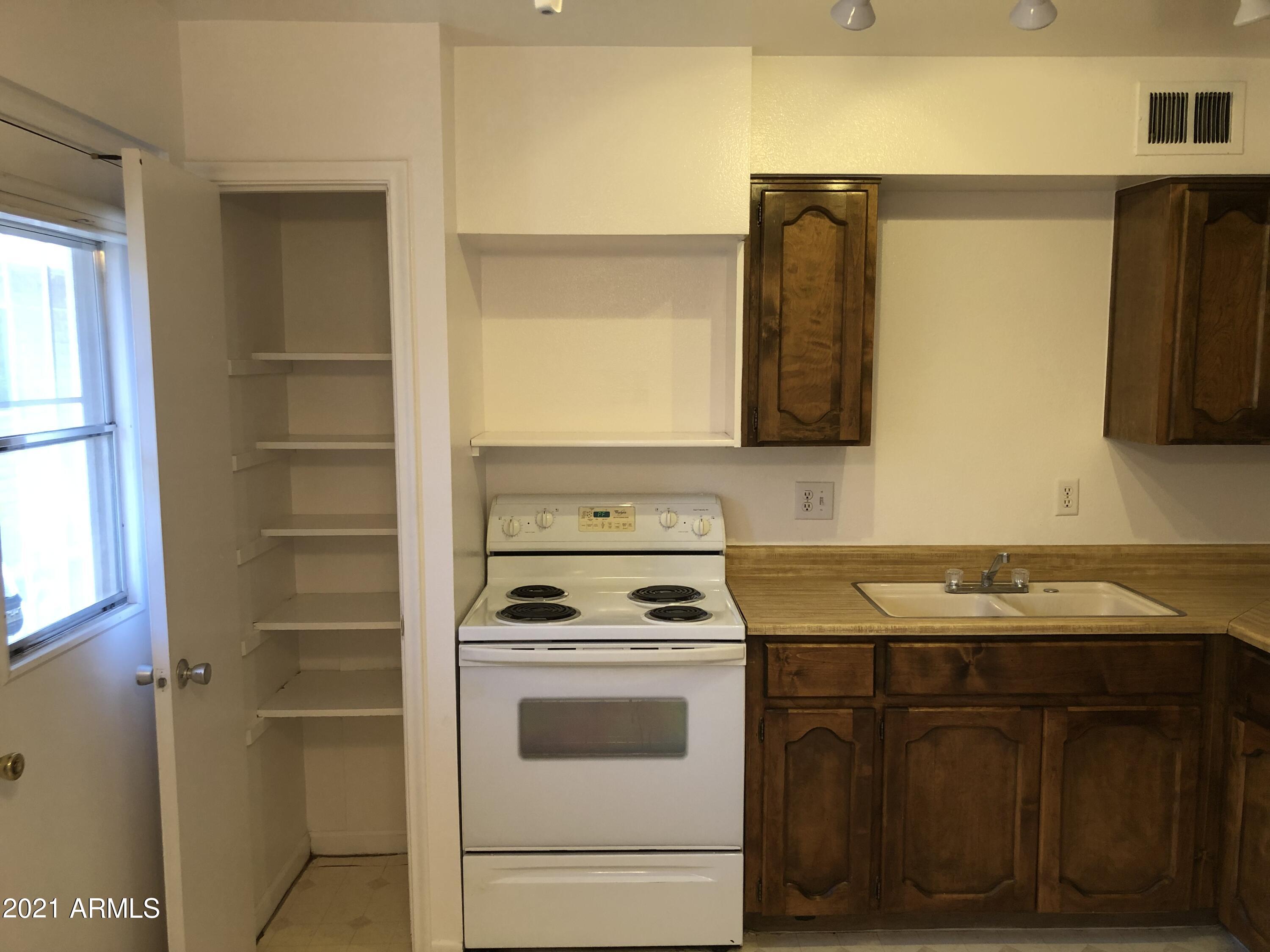 3031 South Rural Road, Unit 41 Tempe, AZ 85282 - Photo 7 of 23 a kitchen with a sink and cabinets