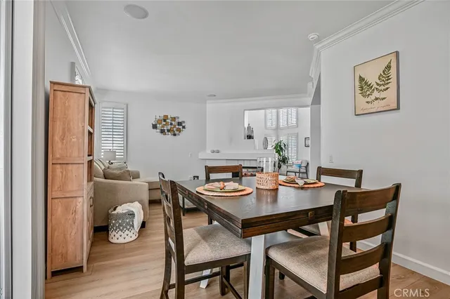 a dining room with furniture and wooden floor