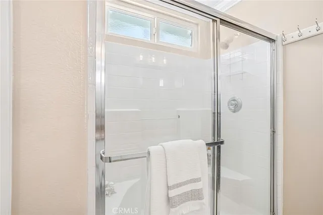 a bathroom with a shower and a glass door