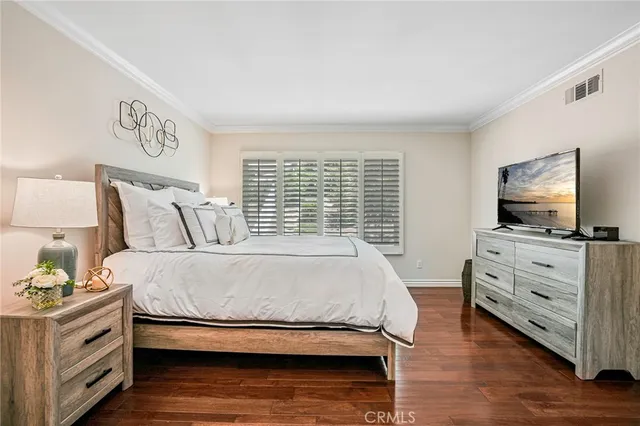 a bedroom with a bed and flat screen tv