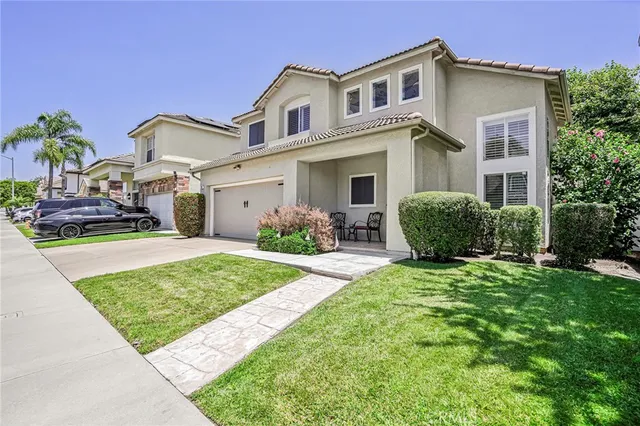 a front view of a house with garden