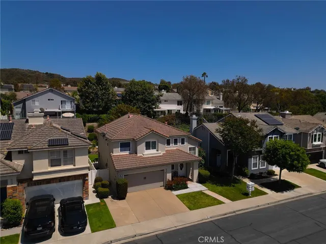 a view of houses with outdoor space and parking