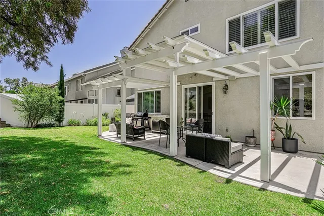 a view of a house with backyard sitting area and garden