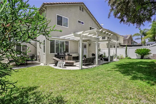 a view of a house with backyard porch and sitting area