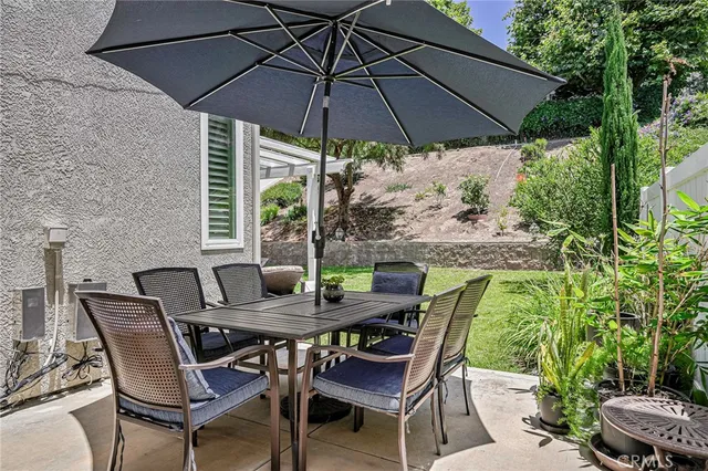 a view of an outdoor space with furniture and umbrella