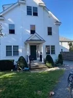 a view of a house with a yard and plants