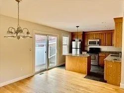 a kitchen with stainless steel appliances granite countertop a refrigerator and a stove top oven