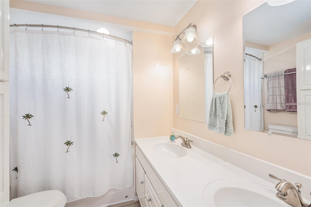 34527 Violet Drive Pinellas Park, FL 33781 - Photo 13 of 27 a bathroom with a sink vanity mirror and toilet