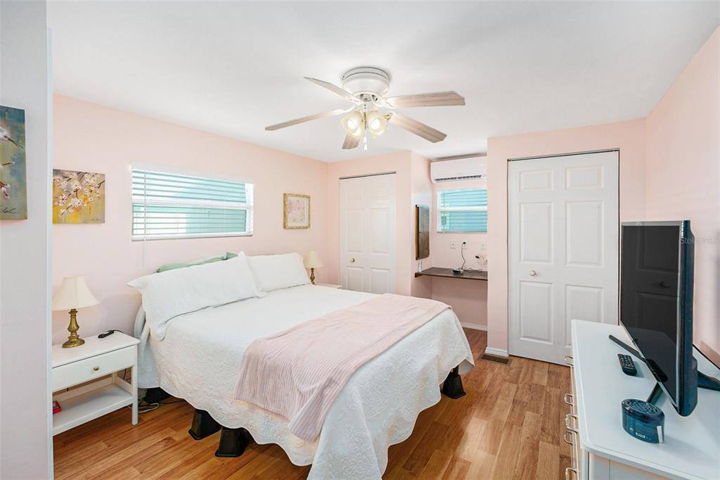 34527 Violet Drive Pinellas Park, FL 33781 - Photo 14 of 27 a bedroom with a bed tv and a chandelier