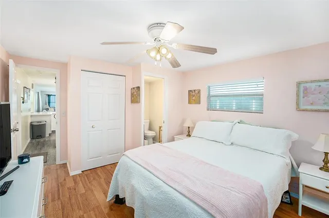a bedroom with a large bed and a chandelier