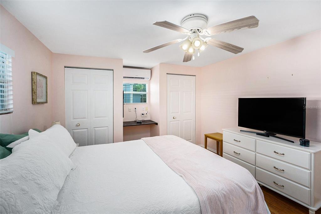 34527 Violet Drive Pinellas Park, FL 33781 - Photo 16 of 27 a bedroom with a bed and a flat screen tv