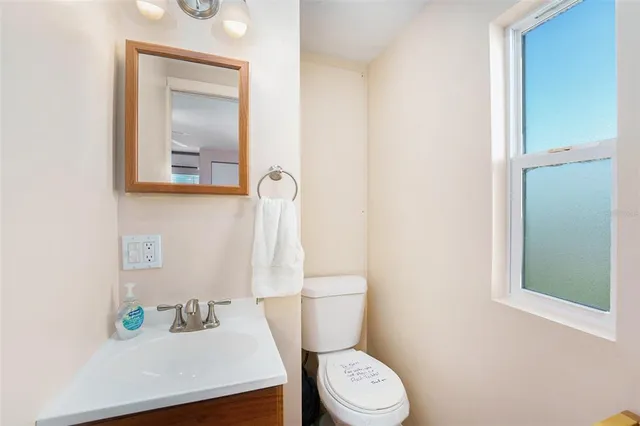 a bathroom with a sink a toilet and a mirror
