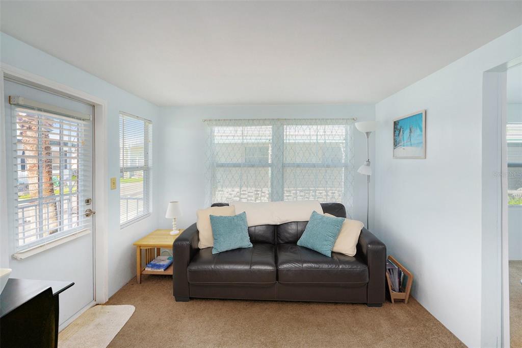 34527 Violet Drive Pinellas Park, FL 33781 - Photo 18 of 27 a living room with furniture and a large window