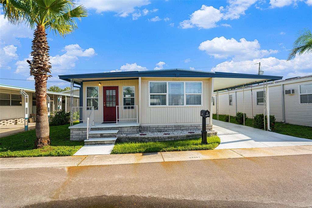 34527 Violet Drive Pinellas Park, FL 33781 - Photo 21 of 27 a front view of a house with a yard and potted plants