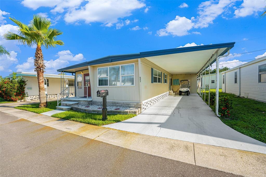 34527 Violet Drive Pinellas Park, FL 33781 - Photo 22 of 27 a front view of a house with a yard and garage