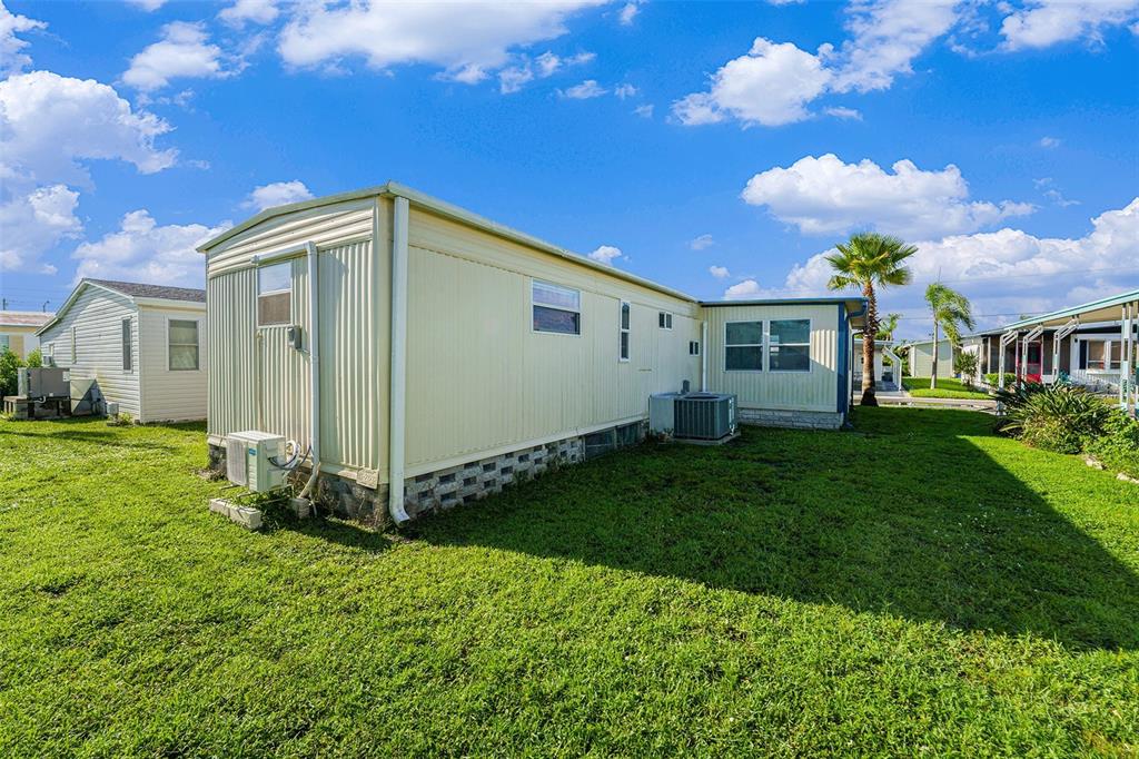 34527 Violet Drive Pinellas Park, FL 33781 - Photo 25 of 27 a front view of a house with garden