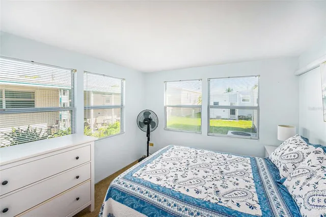 a bed room with a bed and a window