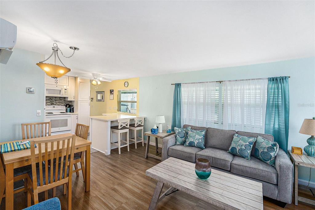 34527 Violet Drive Pinellas Park, FL 33781 - Photo 6 of 27 a living room with furniture a wooden floor and a window