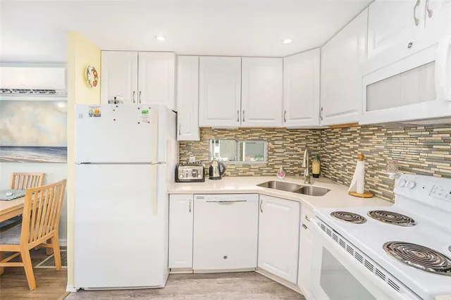 a kitchen with a white cabinets and white appliances