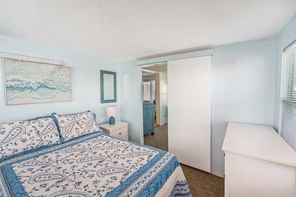 34527 Violet Drive Pinellas Park, FL 33781 - Photo 10 of 27 a bedroom with a bed and a couch