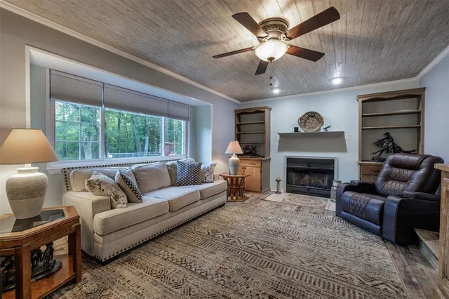 a living room with furniture a fireplace and a large window
