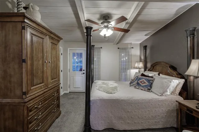 a bedroom with a bed couch and hallway