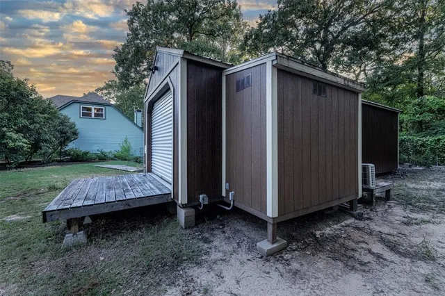 a view of a grassy field with trees in the background
