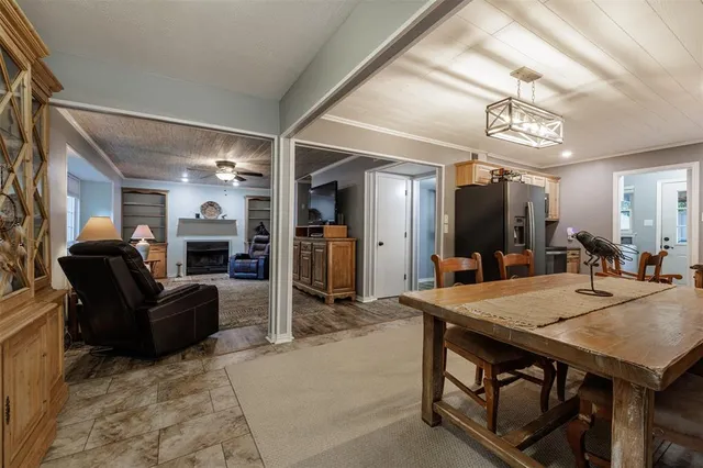a view of kitchen with stainless steel appliances kitchen island granite countertop dining room