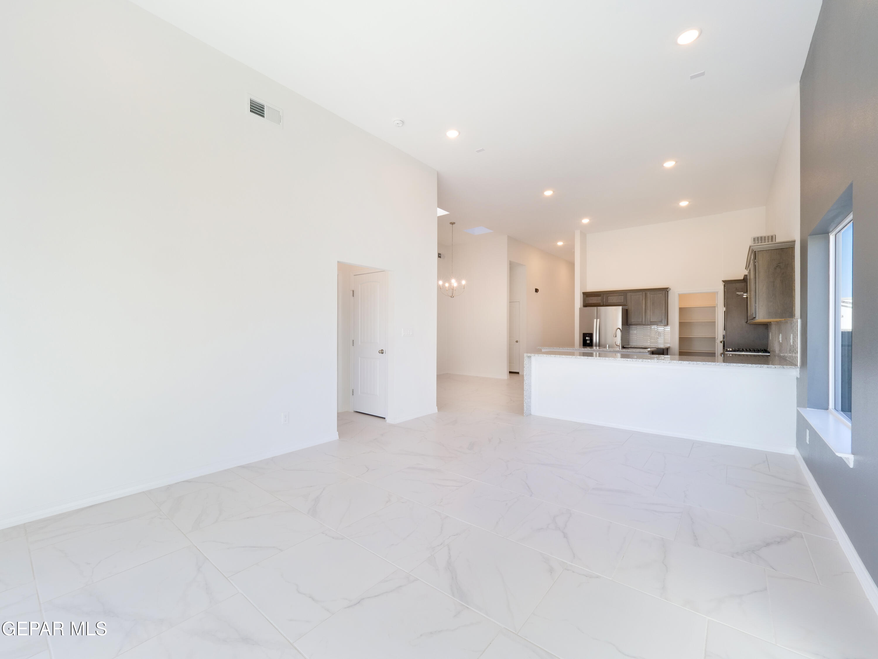 6041 Summer Ridge Santa Teresa, NM 88008 - Photo 6 of 13 a view of a kitchen with a refrigerator and a window