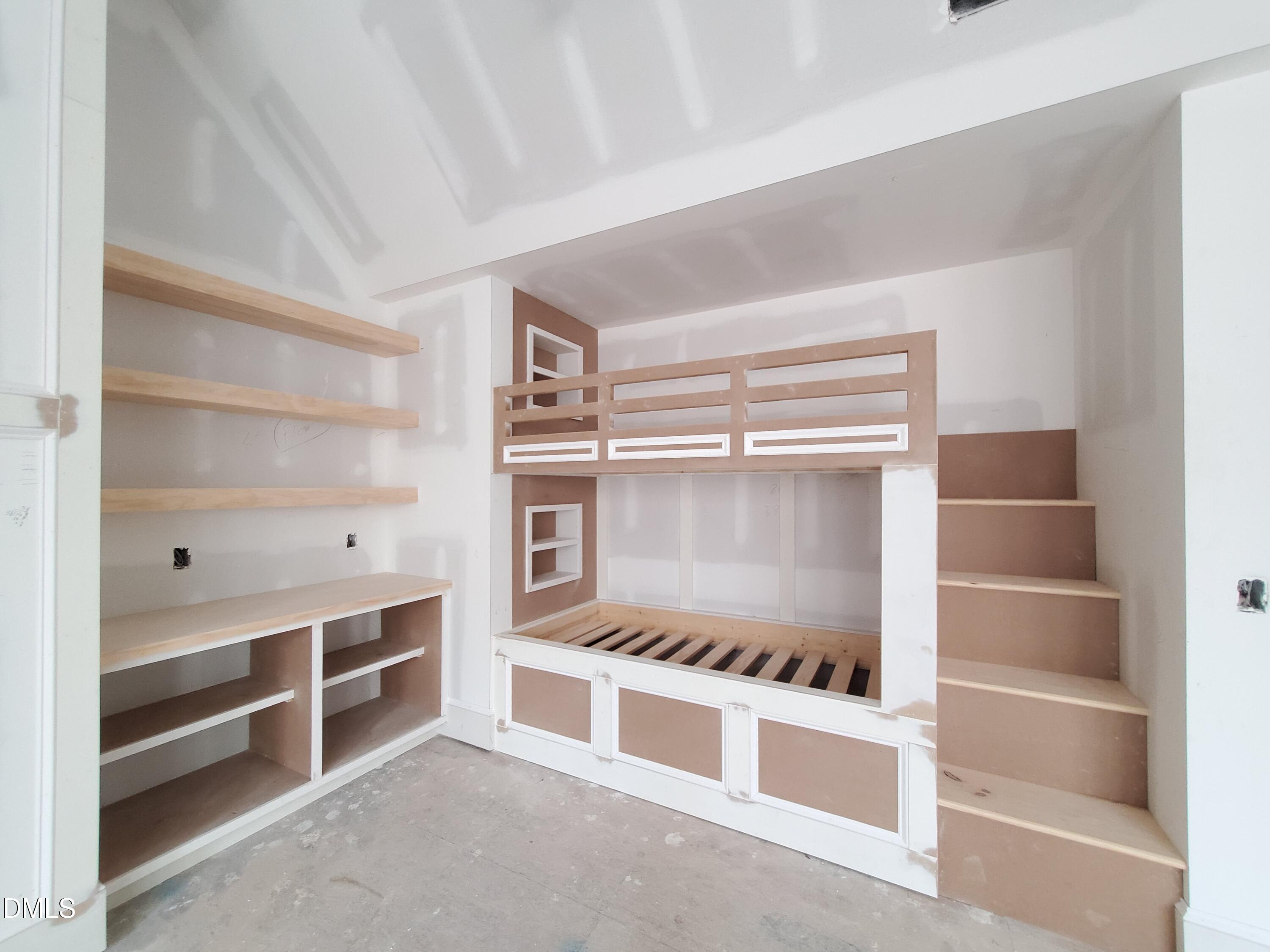 6508 Sanctuary Falls Drive Raleigh, NC 27614 - Photo 22 of 41 a room with shelves on the wall