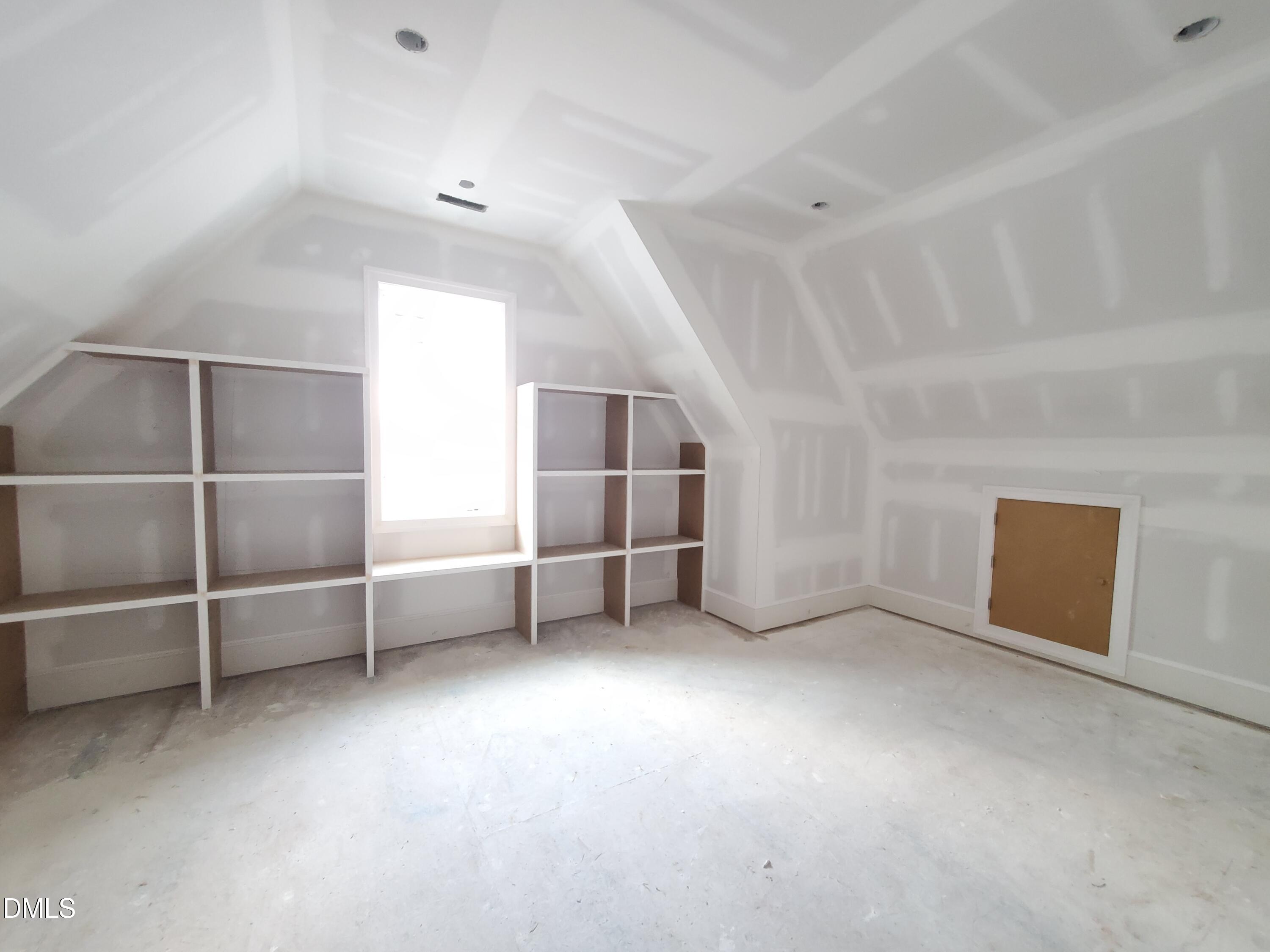 6508 Sanctuary Falls Drive Raleigh, NC 27614 - Photo 32 of 41 a view of empty room with white walls and empty shelves