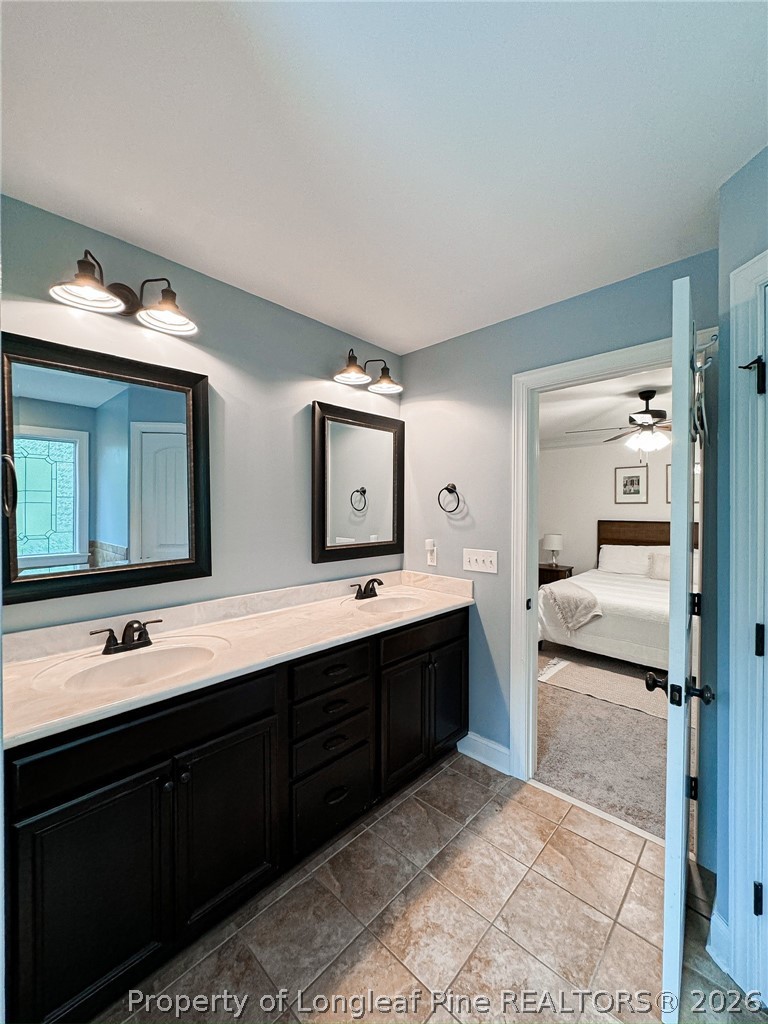 93 Falcon Ridge Drive Spring Lake, NC 28390 - Photo 30 of 50 a spacious bathroom with a granite countertop sink and a mirror